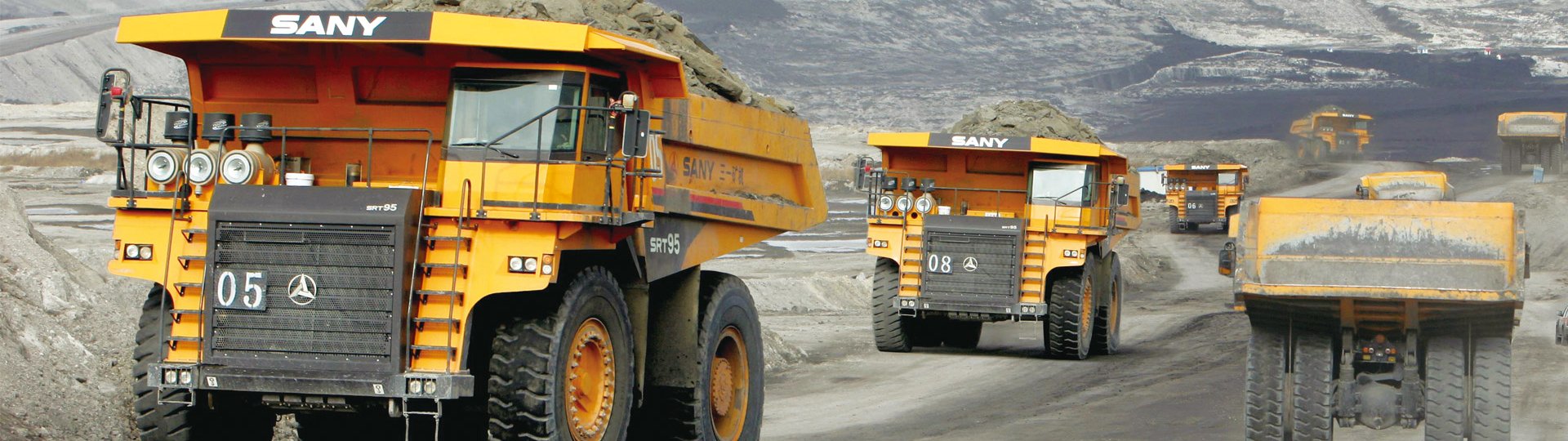 Durable, rigid-frame dump trucks designed for transporting heavy loads in demanding mining and construction environments.